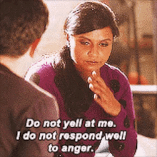 a woman in a purple sweater is talking to a man .