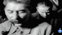 a black and white photo of a man and a woman with the number 2 on the bottom right