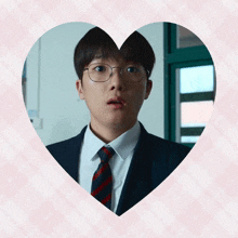 a man in a suit and tie is in a heart shape
