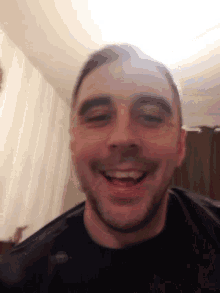 a close up of a man 's face with a smile on it