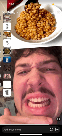 a man with a mustache is making a funny face in front of a bowl of baked beans