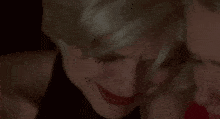 a close up of two women 's faces with their eyes closed