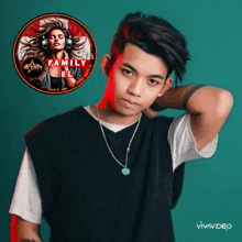 a young man wearing headphones and a necklace is standing in front of a logo for family el