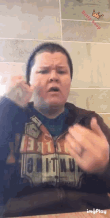 a woman wearing a hoodie that says ' berry boop ' on the bottom