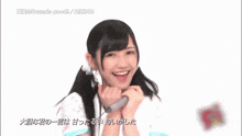 a girl singing into a microphone with the words sounds good akb48 written below her