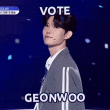 a man in a suit and tie says vote geonwoo