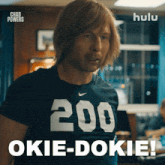 a man wearing a t-shirt that says 200 okie-dokie