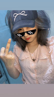 a girl wearing sunglasses and a hat with the letter e on it