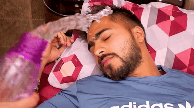 a man with a beard wearing an adidas shirt