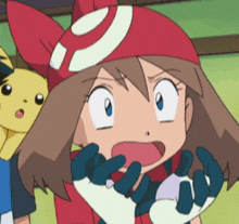 a girl in a red hat with a white circle on it is making a funny face