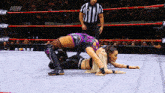 two women are wrestling in a ring with aew written on the ring