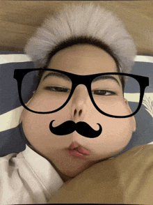 a man with glasses and a mustache on his face