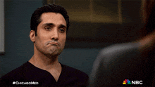 a man in a black shirt with #chicagomed written on the bottom right