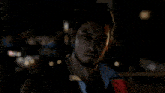 a man in a red suit is covering his mouth