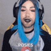 a man with blue hair is wearing headphones and a shirt that says poses