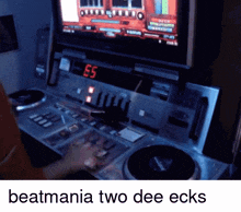 a person is playing a video game with the words beatmania two dee ecks below them
