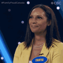 a woman in a yellow jacket with a name tag that says tanya