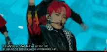 a man with red hair is standing on a stage with a microphone .