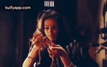 a woman is holding a rope in her hands and looking at it .