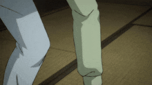 a close up of a person 's leg with a white shirt