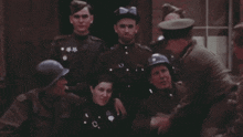 a group of soldiers are posing for a picture with one wearing a blue helmet