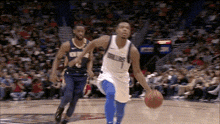 a basketball player in a dallas mavericks uniform dribbles the ball