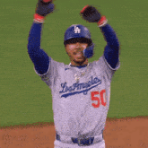 a baseball player with the number 50 on his jersey talks to another player