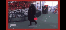 a video of a woman walking with a red purse in front of a christmas tree