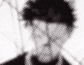 a black and white image of a person 's face