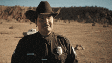 a police officer wearing a cowboy hat has a name tag that says " anderson "