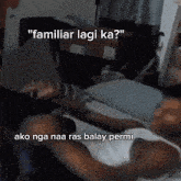 a man in a white tank top is laying on a bed with the words " familiar lagi ka " above him