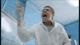 a man in a lab coat with the letter a on his shirt