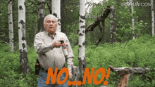 a man in a forest holding a spray bottle with the word no on it