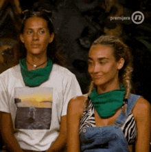 two women wearing green scarves are sitting next to each other in front of a premiera logo