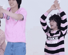 a boy wearing a pink shirt that says frankie rugby