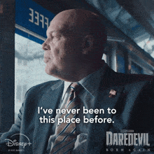 a man in a suit and tie says " i 've never been to this place before " on a daredevil poster