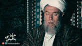 a man with a beard wearing a turban and a striped jacket with the words hakkanibakis on the bottom
