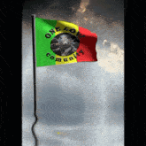a flag that says one love community is flying in the wind