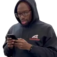 a man wearing a hoodie that says advanced technology is looking at his phone