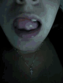 a close up of a woman 's face with her tongue out