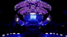 a blurred image of a crowd of people watching a performance