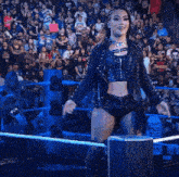 a woman in a wrestling ring with a sign that says prime in the background