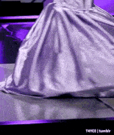 a woman in a purple dress is standing on a table with t4yce tumblr in the corner