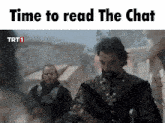 a man with a beard is standing in front of a sign that reads time to read the chat