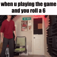 a man in a red shirt is standing next to a chair in a room with a sign that says max blvd