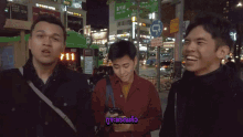 three men are standing in front of a street sign that says ' seoul '