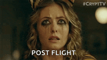 a woman in a tiger costume is crying with tears on her face and the words `` post flight '' written below her .