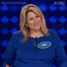 a woman wearing a blue shirt with a name tag that says ana