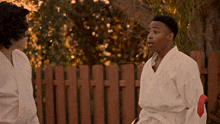 a man in a white karate uniform with a red belt