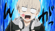 a boy with a bandage on his face is wearing headphones and making a face